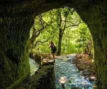 A young woman trekking in the cave at Levada do Caldeirao Verde, Queimadas, Madeira